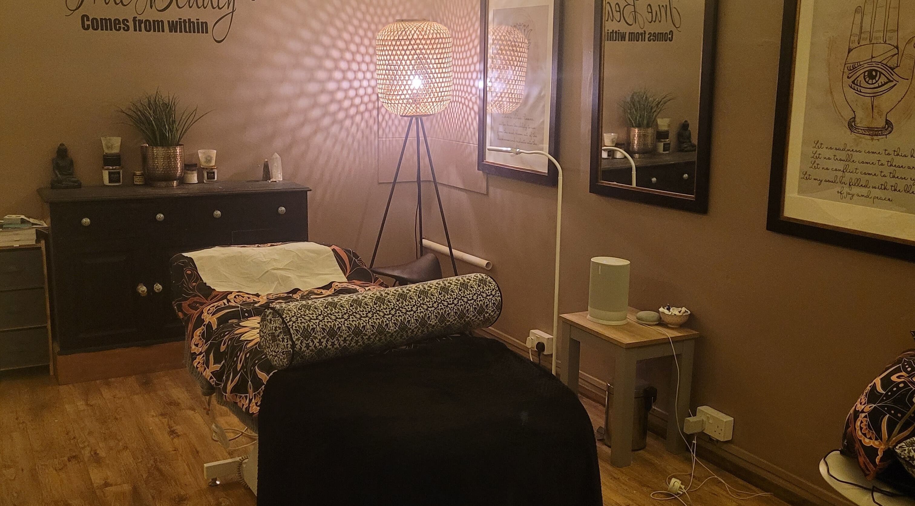 Cozy massage room at LeBris Beauty and Wellness in Saxmundham, England, GB, featuring warm lighting and elegant decor.