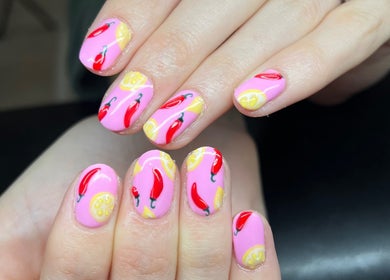 Vibrant chili and lemon nail art at Heathers Beauty, Harlow, England, GB. Stunning manicure design.