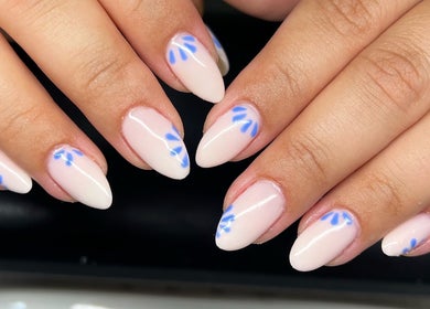 Elegant nude nails with blue floral design at Heathers Beauty, Harlow, England, GB.