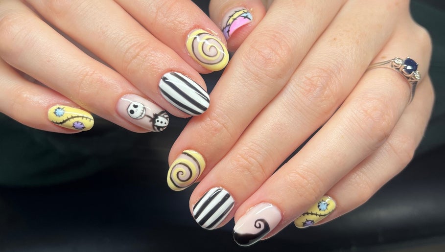 Artistic nail designs at Heathers Beauty, Harlow, England, GB, featuring intricate spiral and character patterns.