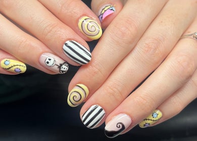 Artistic nail designs at Heathers Beauty, Harlow, England, GB, featuring intricate spiral and character patterns.
