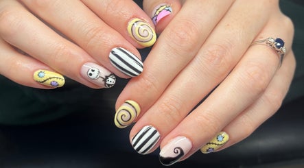 Artistic nail designs at Heathers Beauty, Harlow, England, GB, featuring intricate spiral and character patterns.