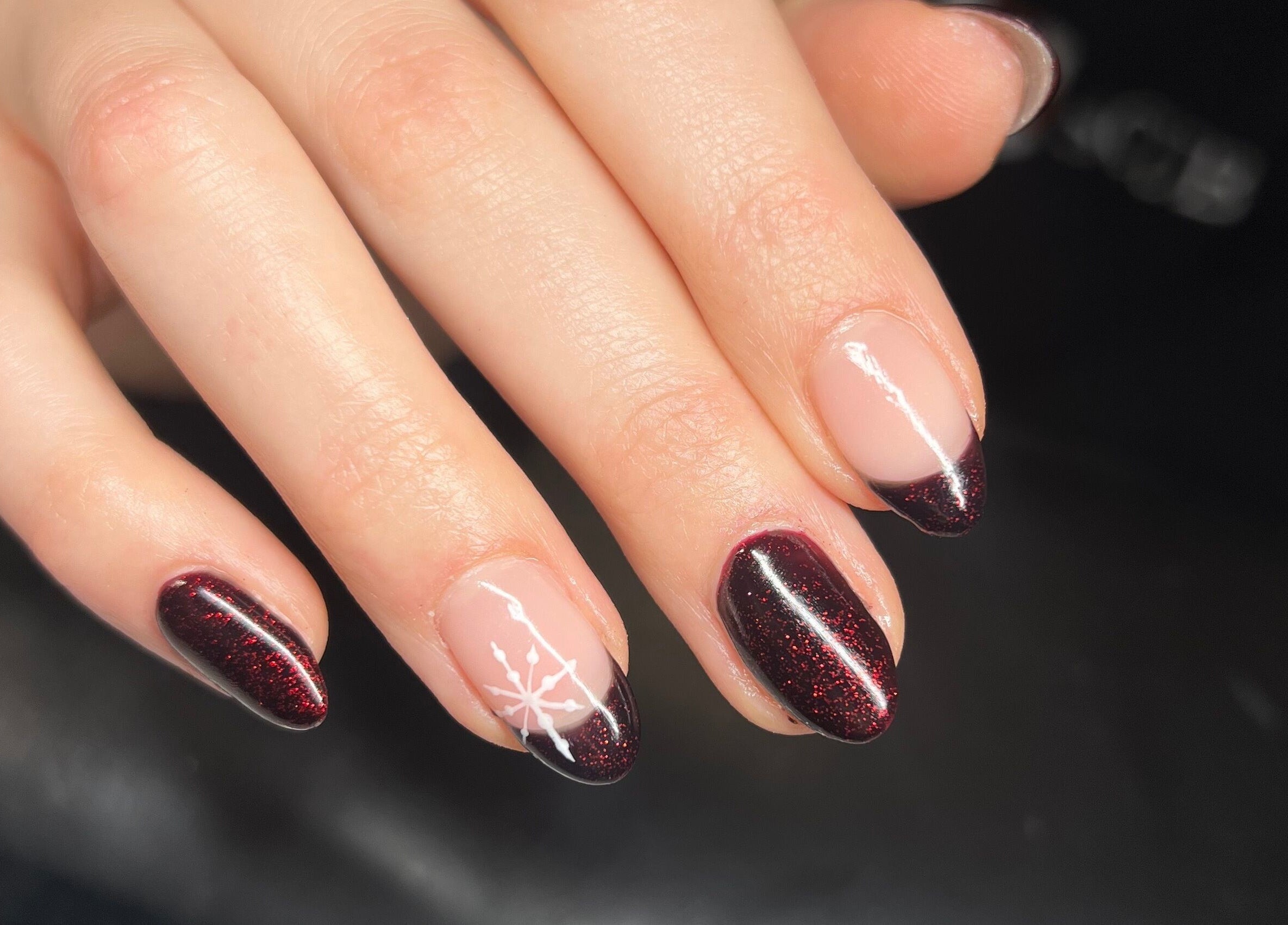 Elegant nail art with dark glitter at Heathers Beauty, Harlow, England, GB.