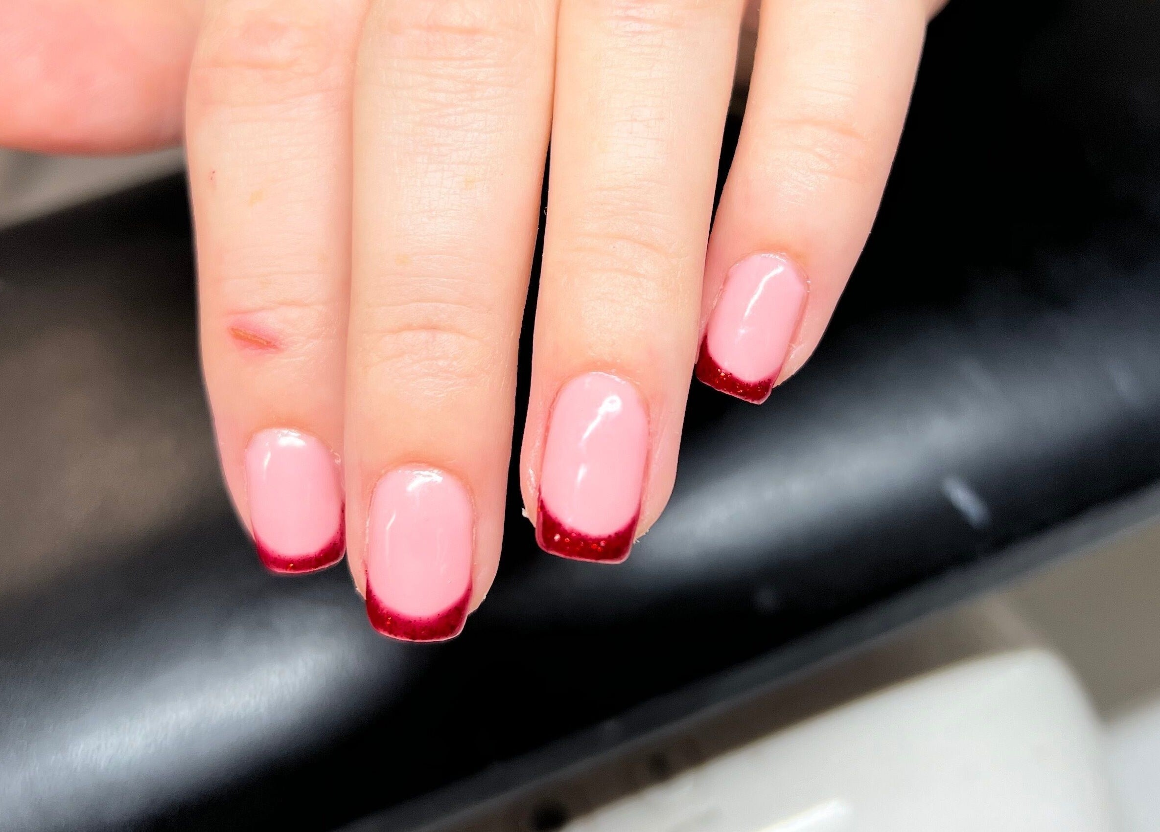 Stylish red-tipped nails at Heathers Beauty in Harlow, England, GB, showcasing expert manicure services.