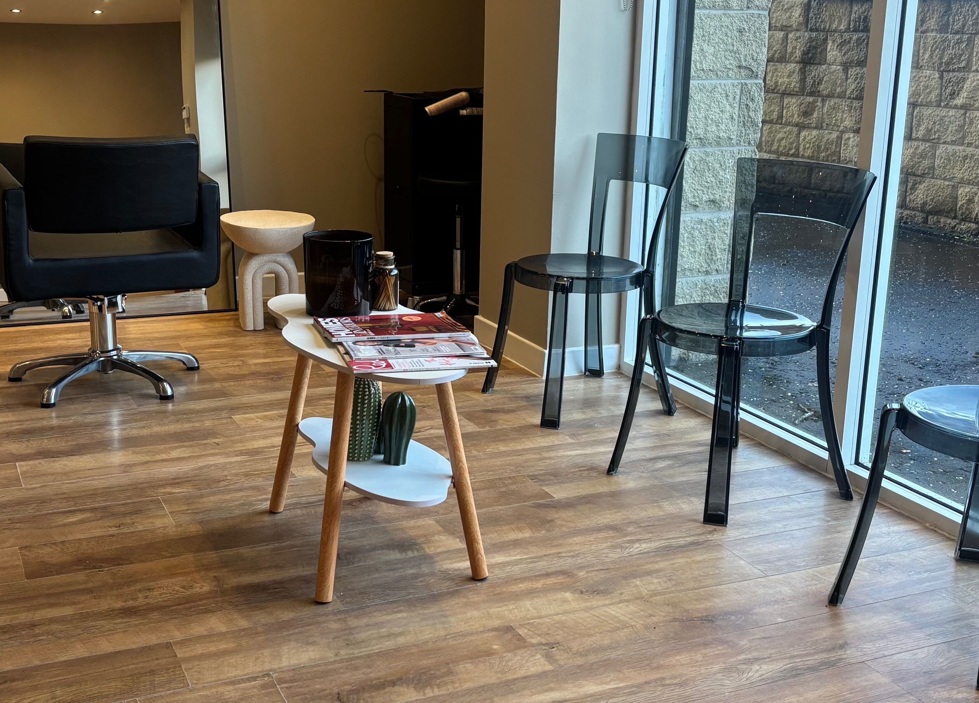 Modern waiting area in Cloud Studio, Livingston, Scotland, GB with sleek chairs and a stylish table.