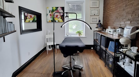 Cozy treatment room at Anaé Esthétique, Montréal, Québec, CA with modern equipment and calming decor.