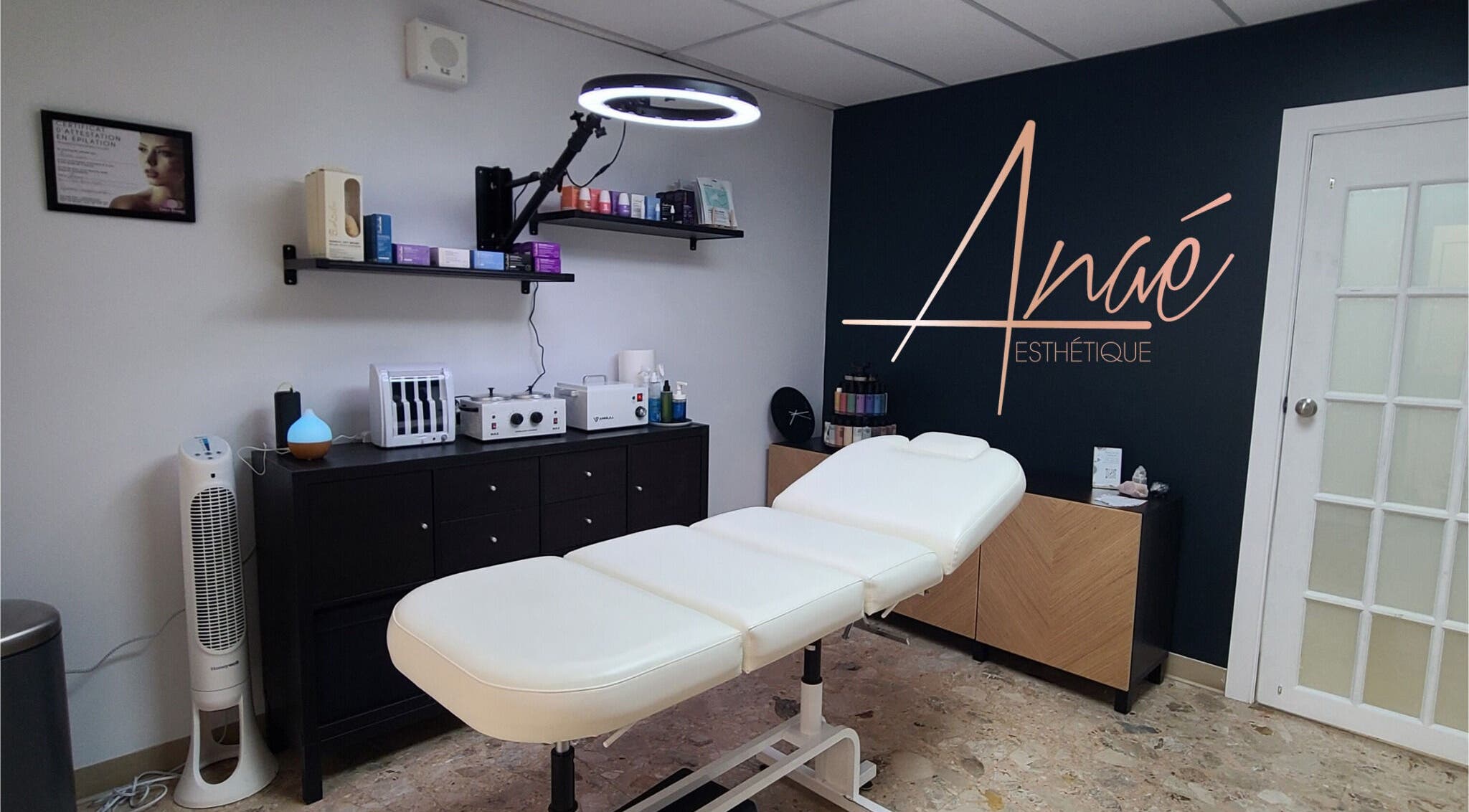 Modern treatment room at Anaé Esthétique, Montréal, Québec, CA, featuring a sleek massage table and elegant decor.