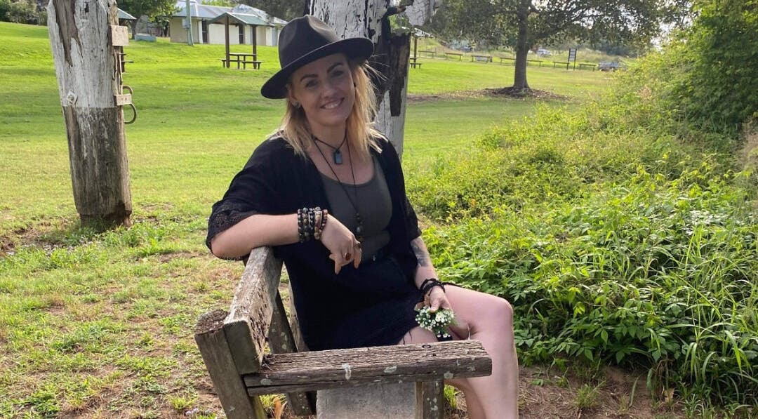 Woman sitting on a bench at Cobi-Jane Intuitive Connections in Belmont North, New South Wales, AU.