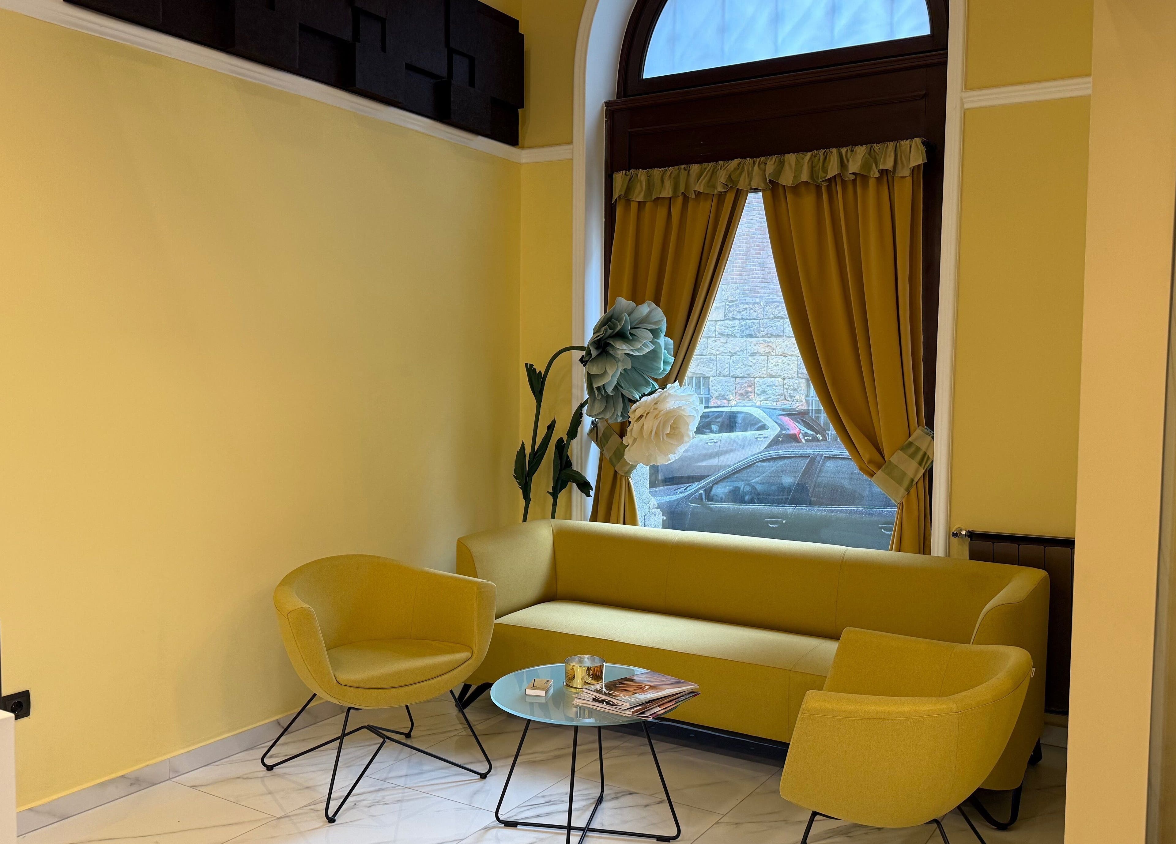 Chic yellow seating area at Nail Berry, Budapest, Magyar, HU with stylish decor and natural light.