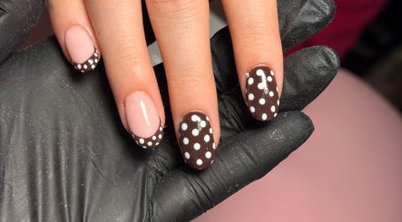 Polka dot nail design at CWL Collective in Glasgow, Scotland, GB. Chic nail art with black gloves.