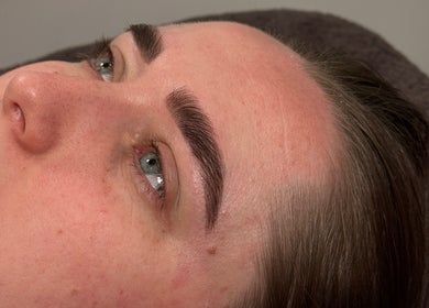 Close-up of a woman's face with flawless skin at CWL Collective, Glasgow, Scotland, GB.