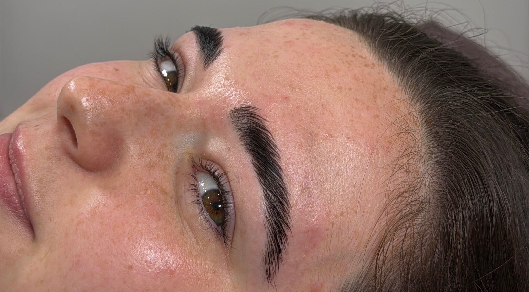 Close-up of a refreshed face at Cwl Collective, showcasing glowing skin in Glasgow, Scotland, GB.