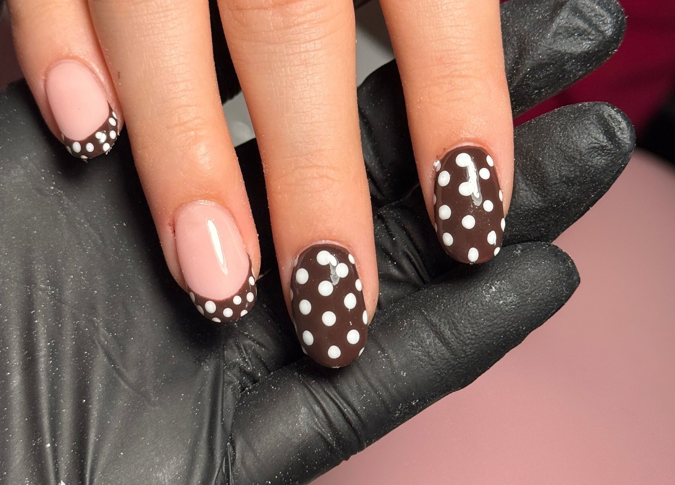 Polka dot nail art at Cwl Collective, Glasgow, Scotland, GB. Stylish manicure with dark and nude tones.