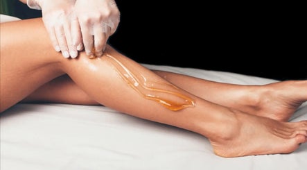 Sugaring treatment on a leg at Sugar It Beauty in San Diego, California, US for silky smooth skin.