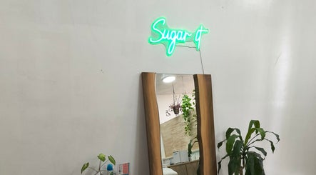 Modern mirror and neon sign at Sugar It Beauty, San Diego, California, US.