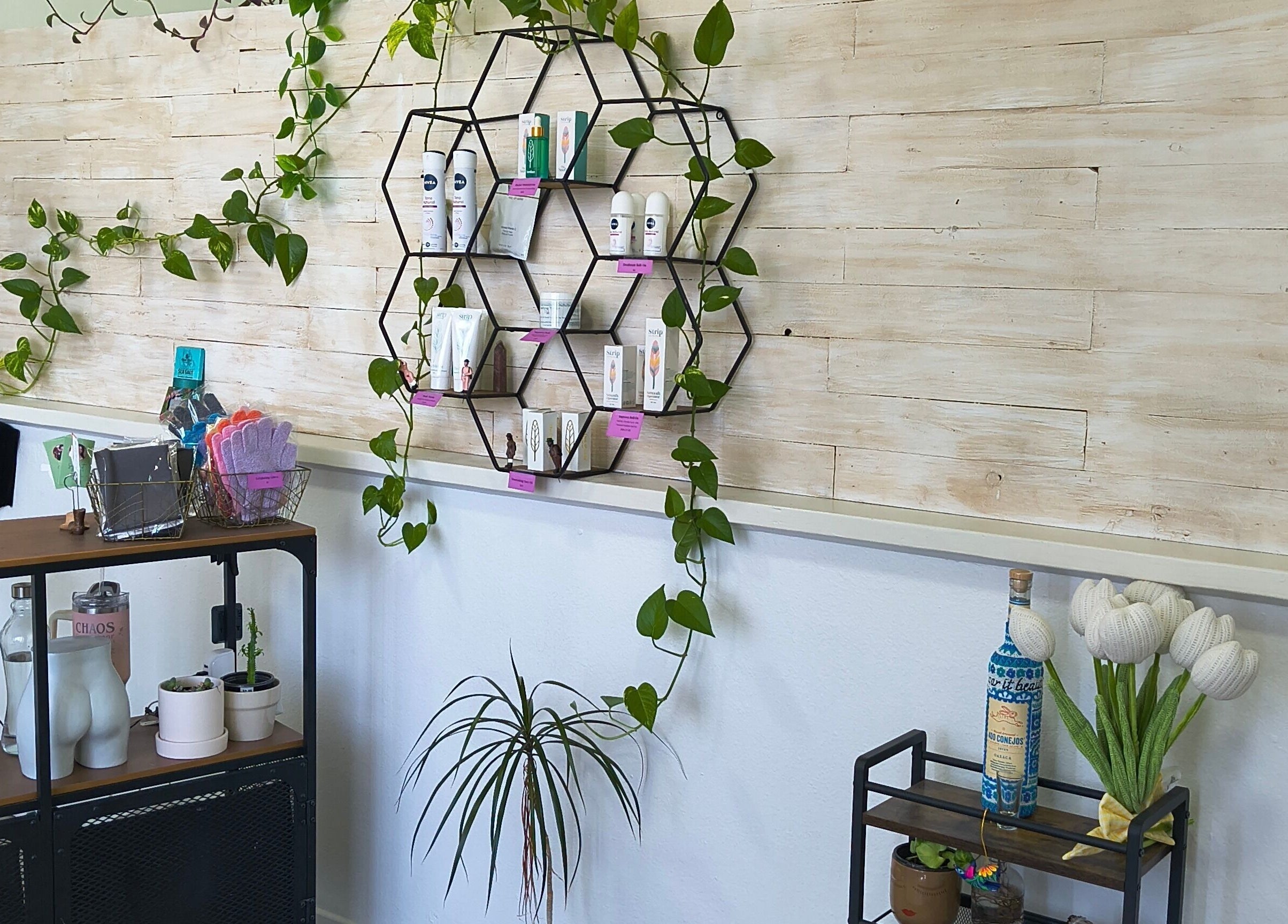 Chic product display at Sugar It Beauty, San Diego, California, US with stylish decor and greenery.