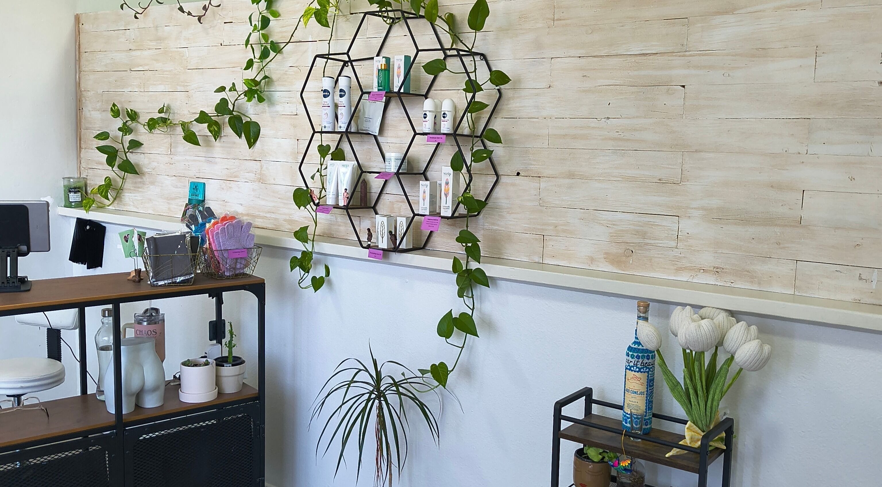 Chic product display at Sugar It Beauty, San Diego, California, US with stylish decor and greenery.