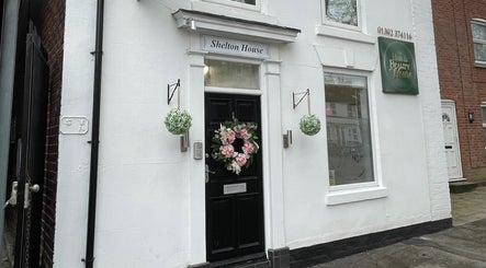 Charming exterior of Scorpio Nails & Beauty in Doncaster, England, GB with floral decor and signage.