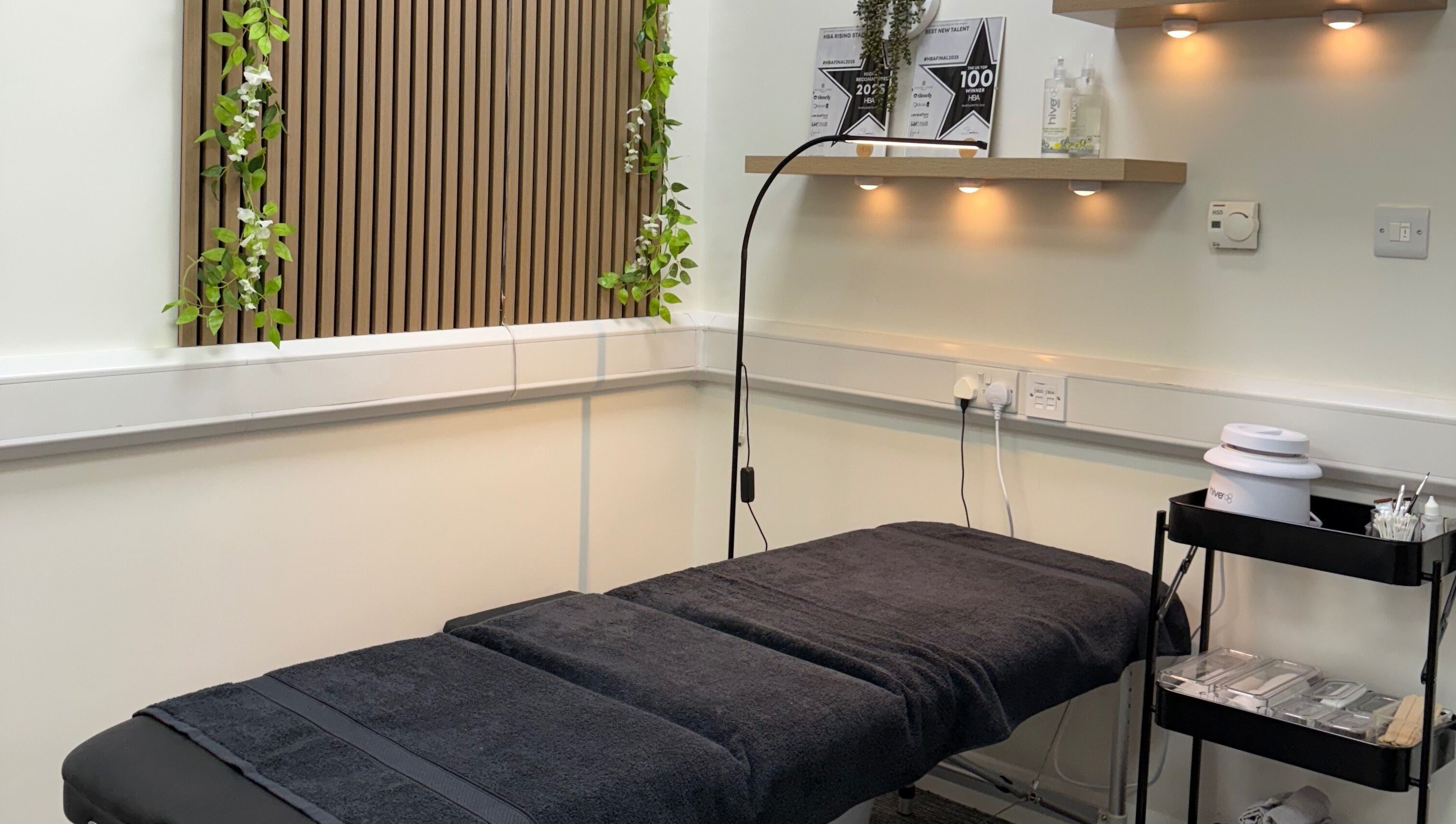 Relaxing treatment room at Scorpio Nails & Beauty, Doncaster, England, GB with spa bed and ambient lighting.