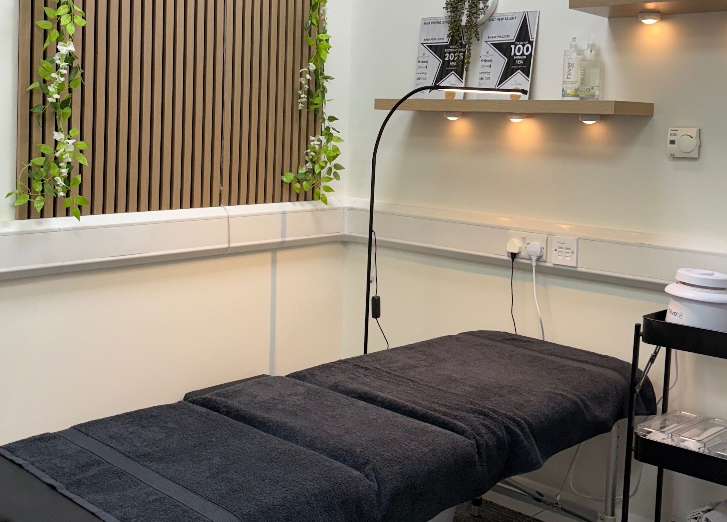 Relaxing treatment room at Scorpio Nails & Beauty, Doncaster, England, GB with spa bed and ambient lighting.