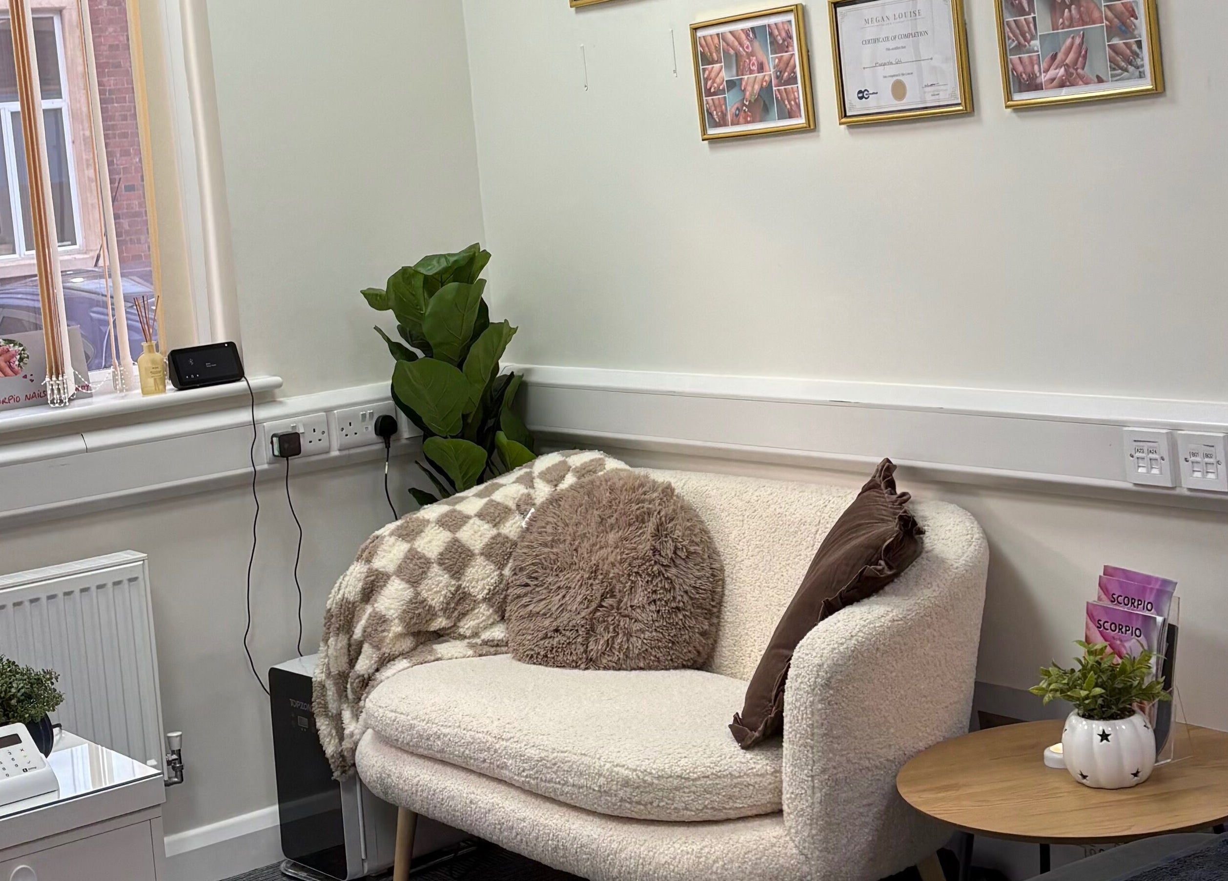 Relaxing seating area at Scorpio Nails & Beauty, Doncaster, England, GB with elegant decor and lush plant.