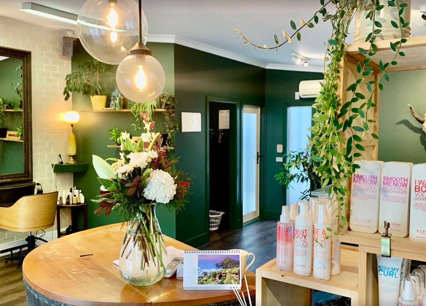Stylish interior of Tonic Hairdressing in Raglan, Waikato, NZ with plants and beauty products.