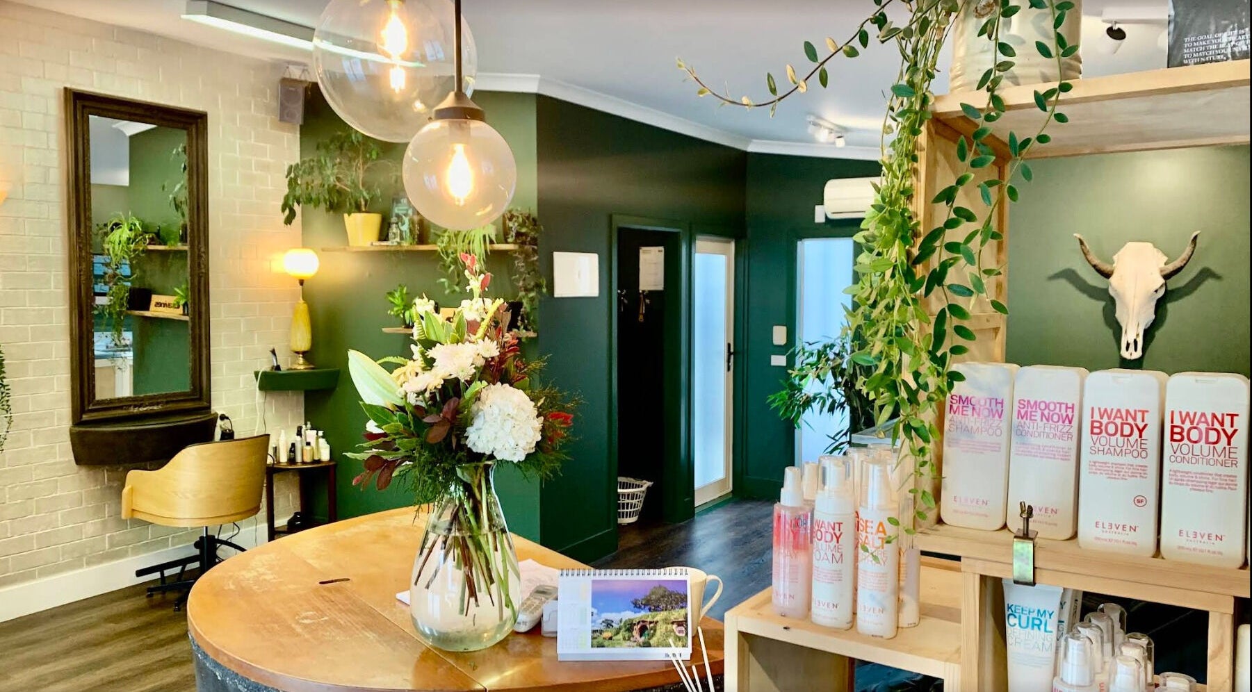 Stylish interior of Tonic Hairdressing in Raglan, Waikato, NZ with plants and beauty products.