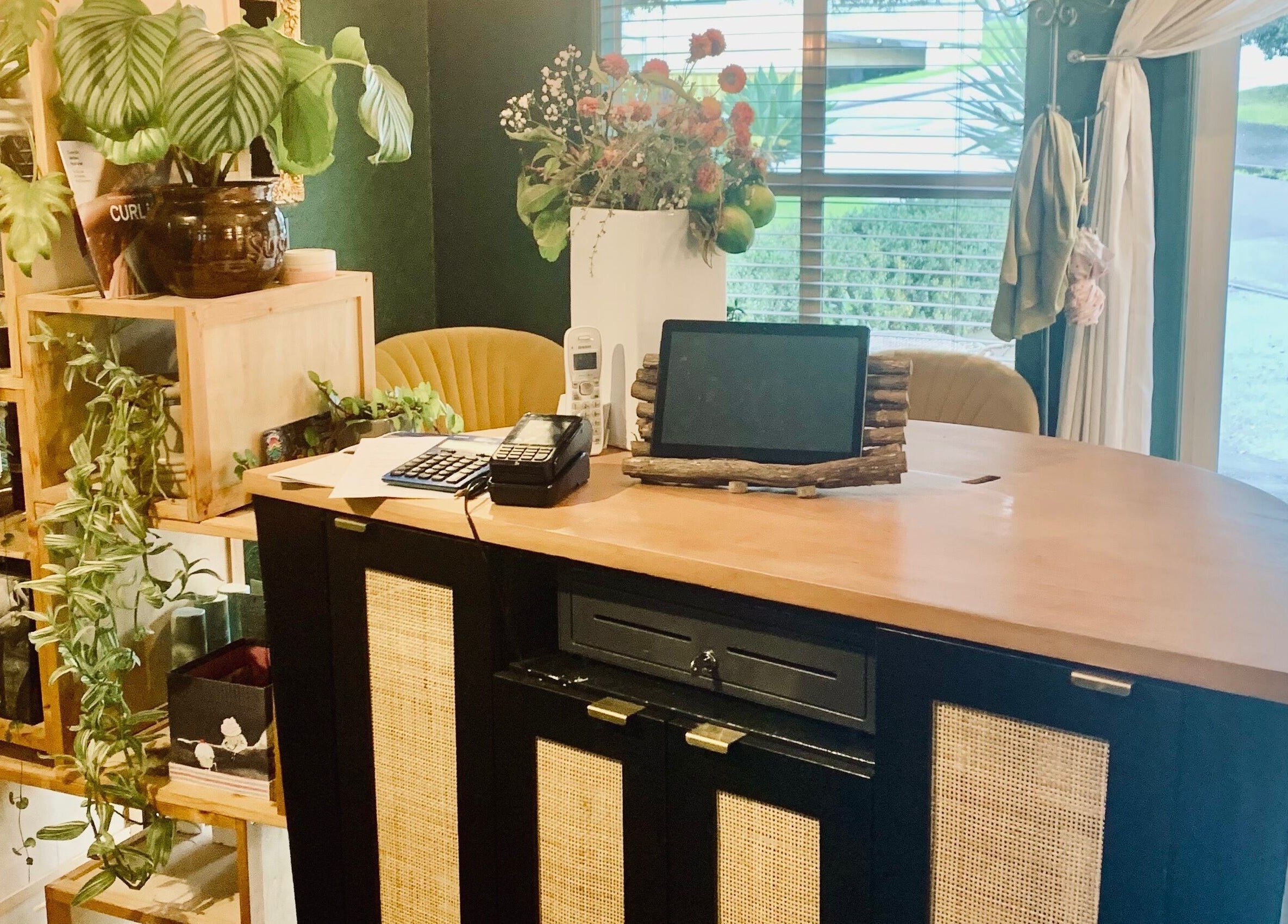 Welcoming reception at Tonic Hairdressing, Raglan, Waikato, NZ with plants and elegant decor.