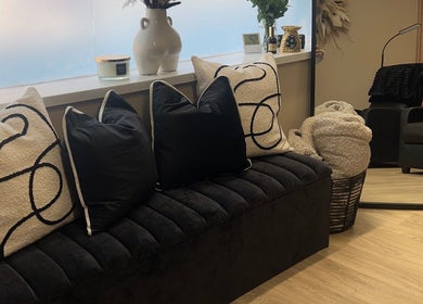 Cozy seating with plush pillows at The Babe Cave, Sheffield, England, GB. Elegant decor enhances relaxation.