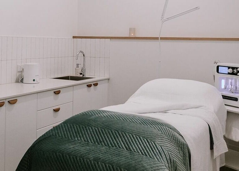 Relaxing treatment room at Numaven, Merewether, New South Wales, AU, showcasing elegant decor and spa equipment.