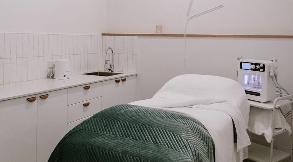 Relaxing treatment room at Numaven, Merewether, New South Wales, AU, showcasing elegant decor and spa equipment.