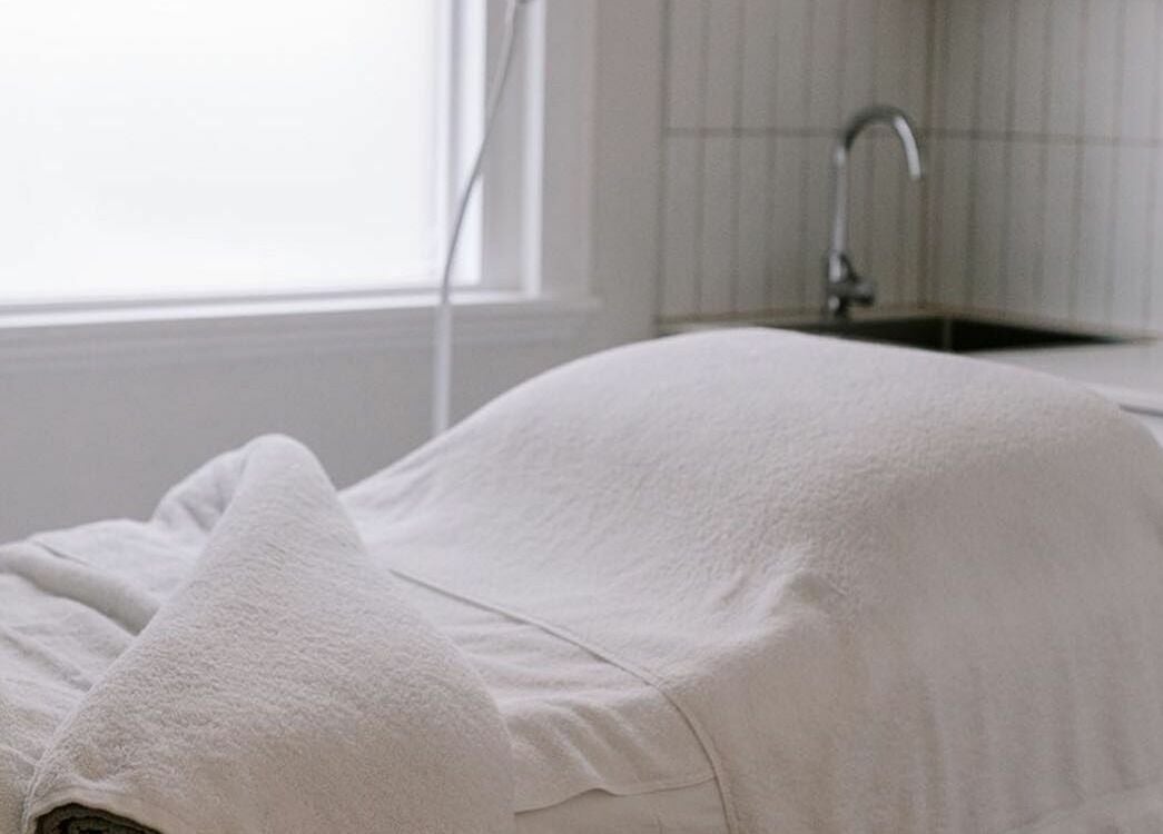 Luxurious spa treatment room at Numaven, Merewether, New South Wales, AU, with a plush massage table.