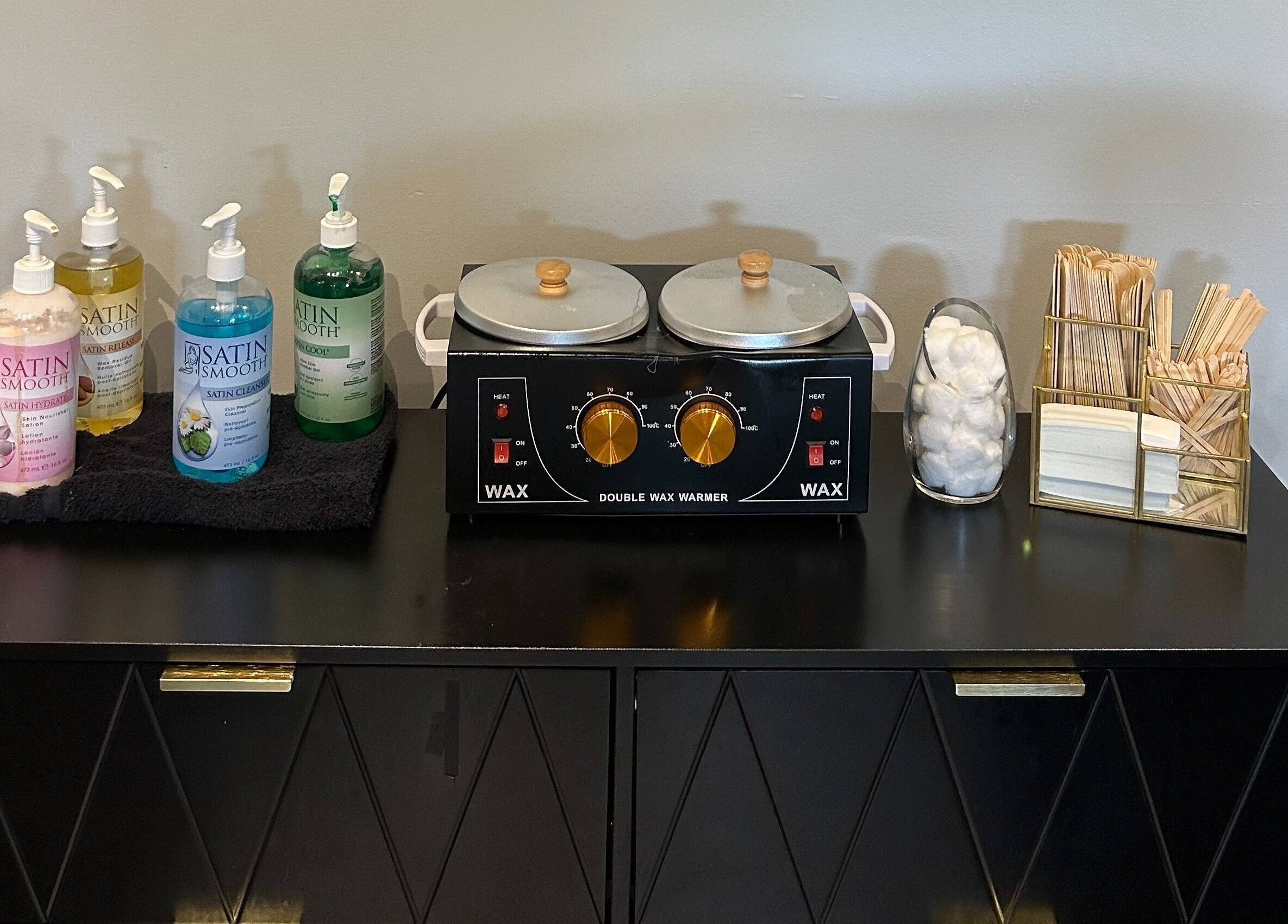 Waxing essentials setup at Emerald Salon, Harrisonville, Missouri, US, featuring a double wax warmer.