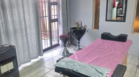 Relaxing spa room at Dramatyes Lash Lounge, Springs, Gauteng, ZA with massage table and cozy decor.