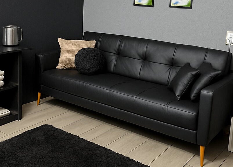 Stylish black sofa in Dramatyes Lash Lounge, Springs, Gauteng, ZA. Modern elegance and comfort.