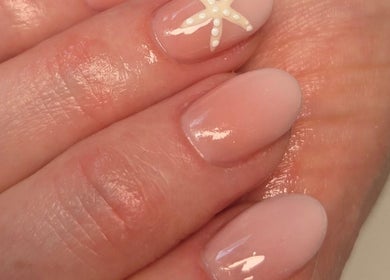 Elegant nail art with starfish design at Bee You Nails, Warsash, England, GB.
