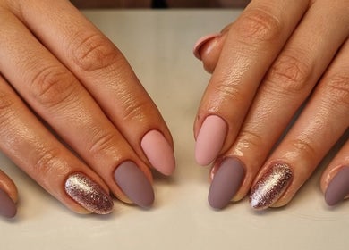 Stylish purple and pink nails with glitter at Bee You Nails, Warsash, England, GB.