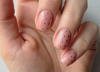 Close-up of a hand with dotted nude nails, showcasing nail art at Bee You Nails, Warsash, England, GB.