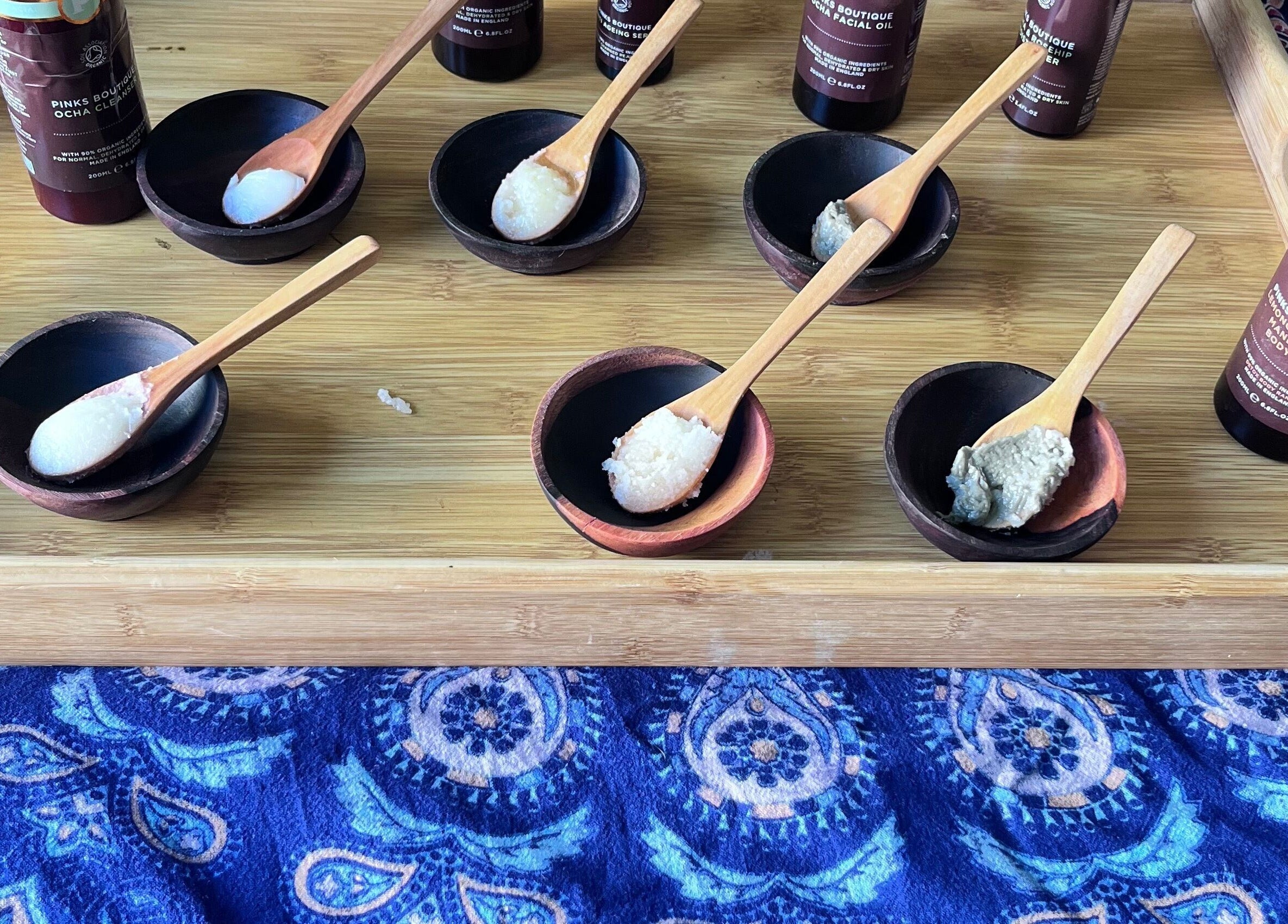 Various spa products displayed on a wooden tray at Nadine Louise, Salisbury, England, GB.