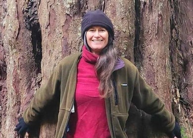 Person hugging a large tree outside Amorah Rose Intuitive, Whakatane, Bay Of Plenty, NZ