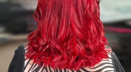 Stunning red wavy hairstyle at H Gcreativehair, Plymouth, England, GB, showcasing vibrant hair color and style.