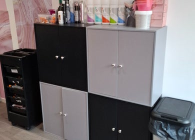 Organized salon storage cabinets at H Gcreativehair, Plymouth, England, GB.