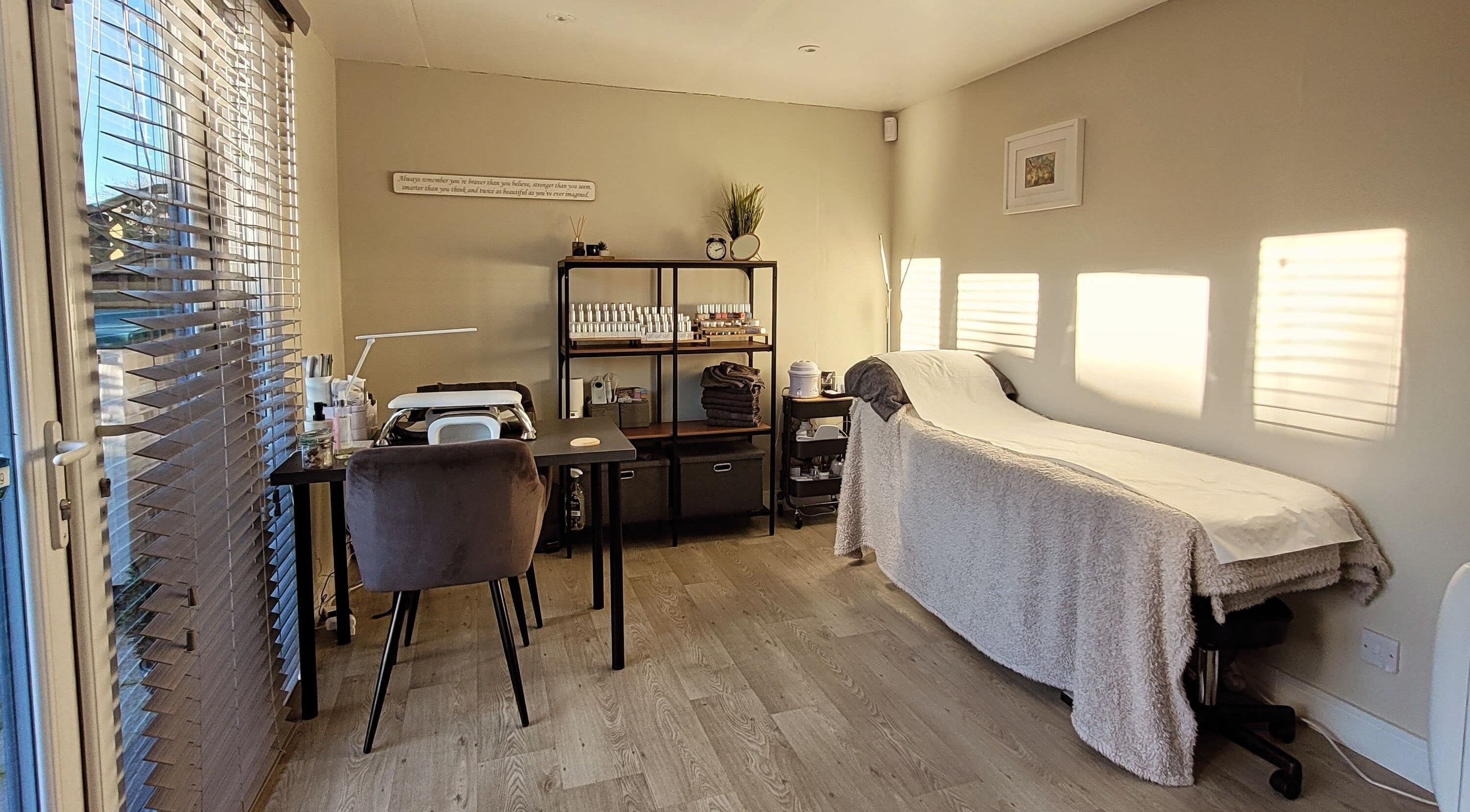 Elegant spa treatment room at Beauty by Leanne in Timperley, England. Sunlight casts gentle warmth.