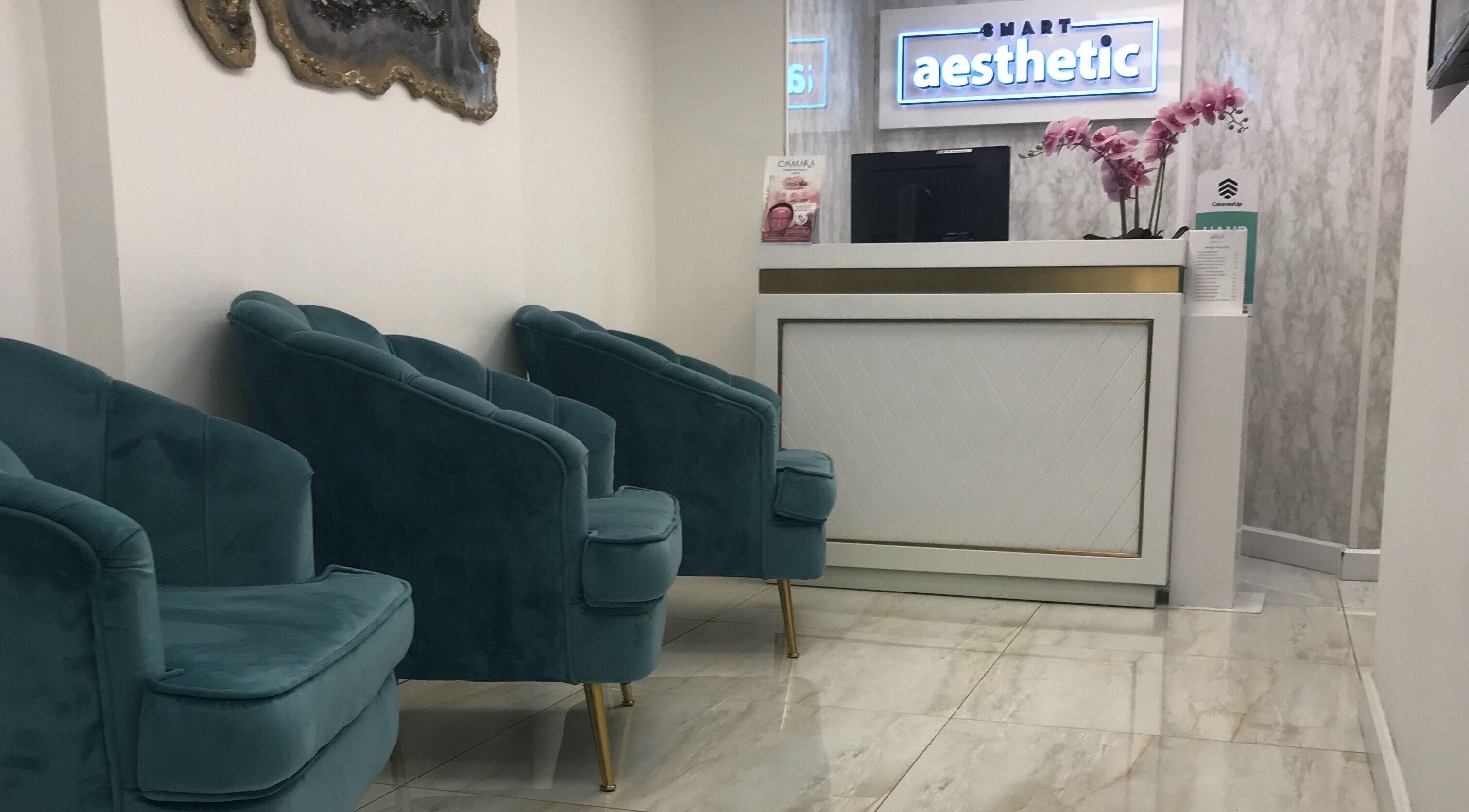 Chic reception area at Sonis Body and Mind, London, England, GB, featuring plush seating and modern decor.
