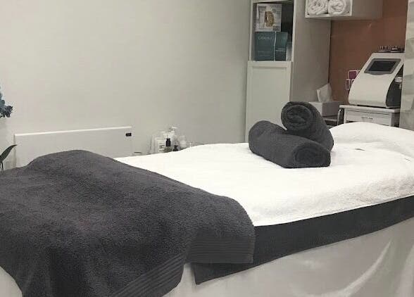 Peaceful treatment room at Sonis Body and Mind, London, England, GB with spa bed and elegant decor.
