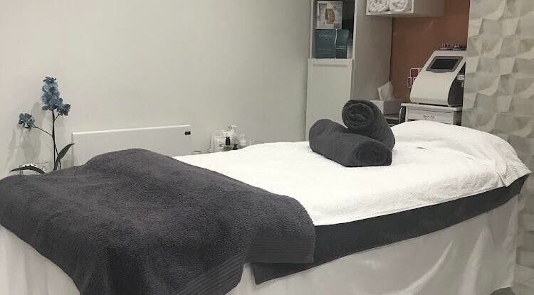 Peaceful treatment room at Sonis Body and Mind, London, England, GB with spa bed and elegant decor.