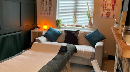 Warm, inviting therapy room at Pembrokeshire Sports Massage, Begelly, Wales, GB with a massage bed and ambient lighting.