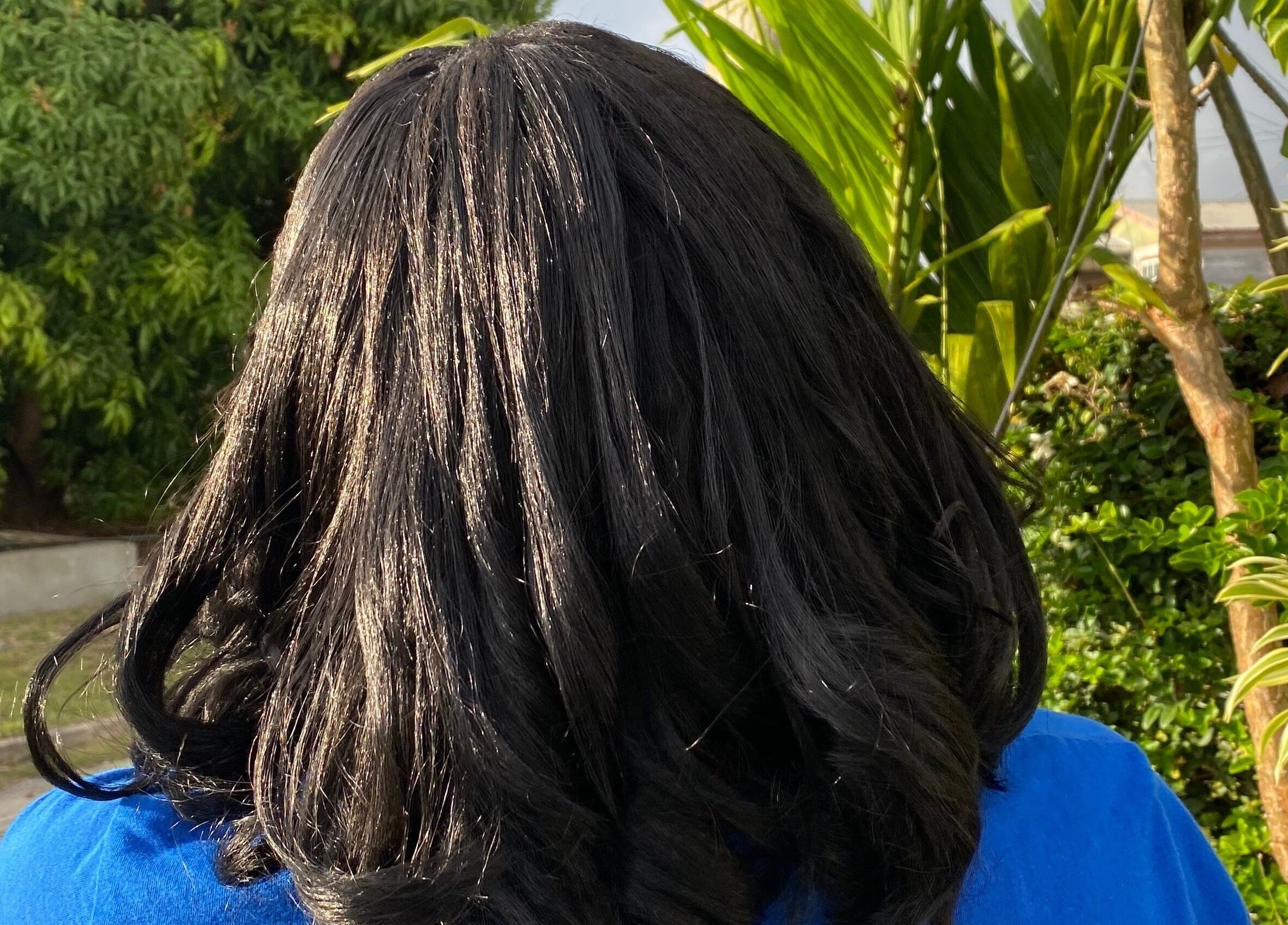 Elegant dark hair styled at Flux Beauty, Oistins, Christ Church, BB amid lush greenery.