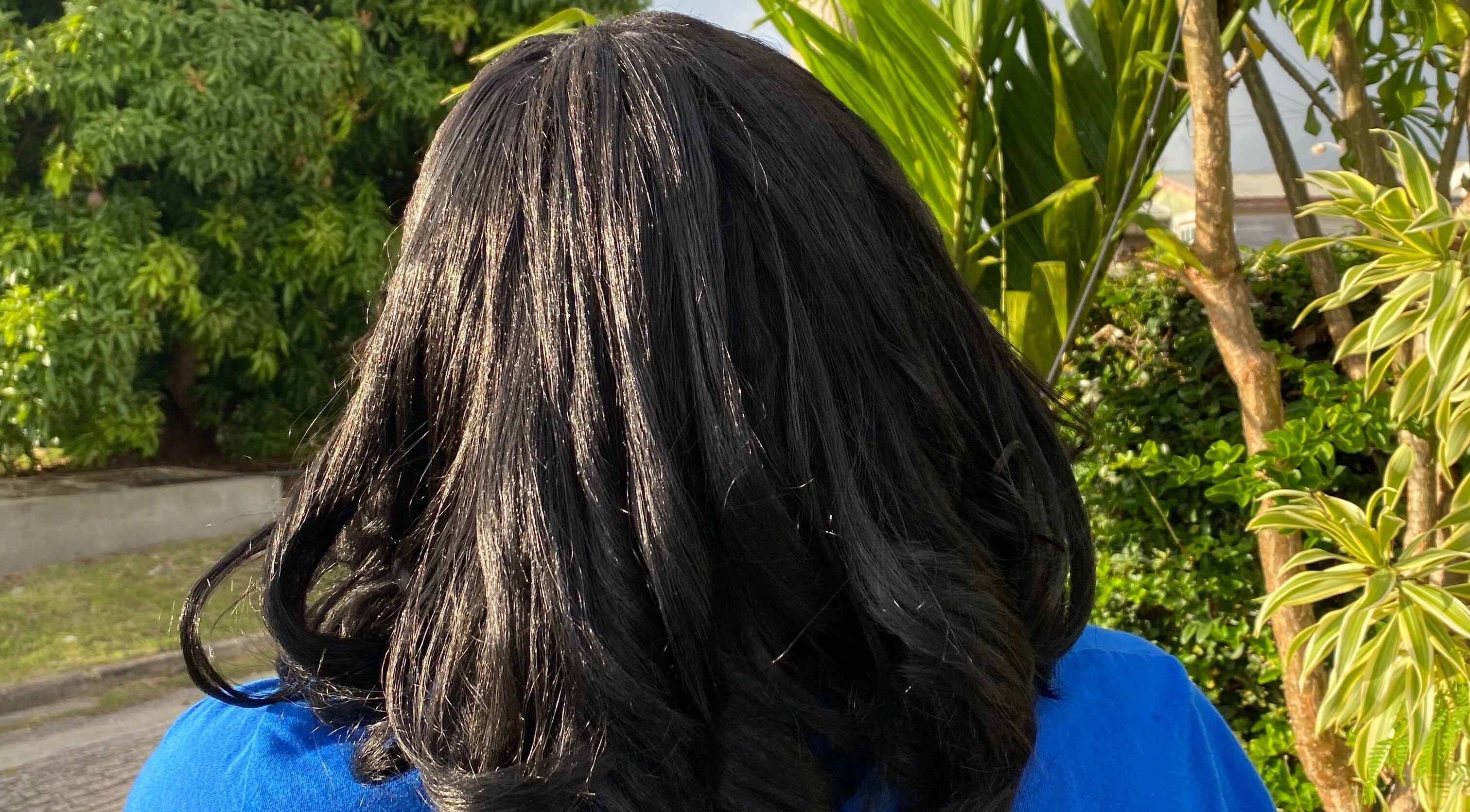 Elegant dark hair styled at Flux Beauty, Oistins, Christ Church, BB amid lush greenery.