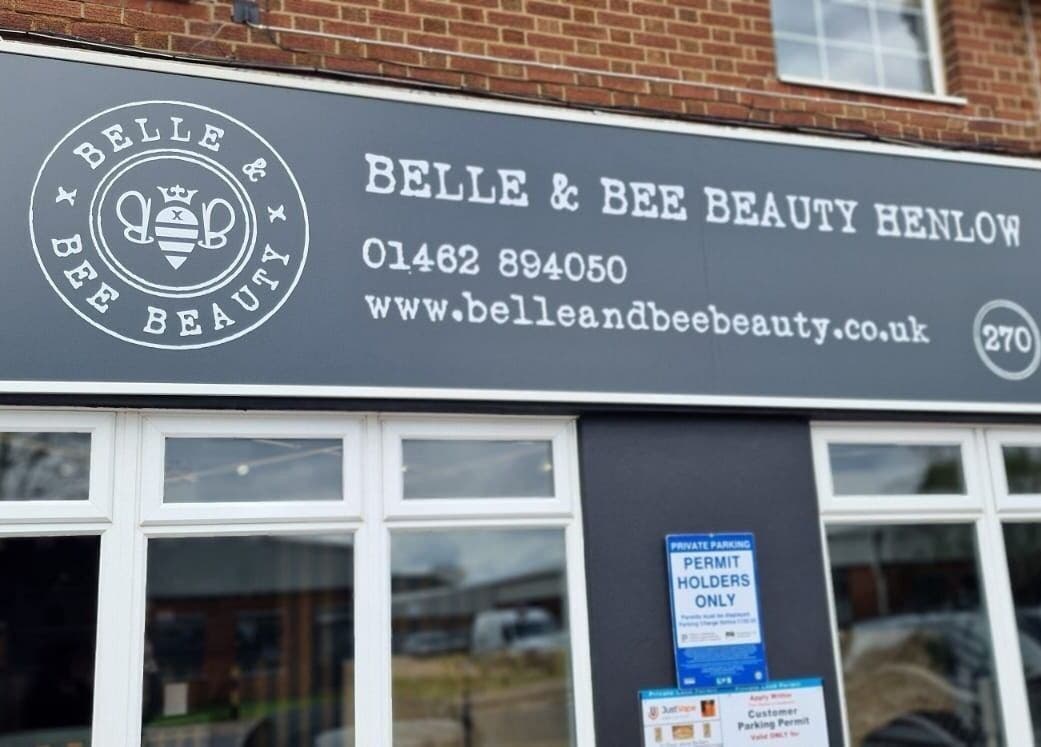 Belle & Bee Beauty X Henlow storefront sign in Henlow Camp, England, GB with contact details.